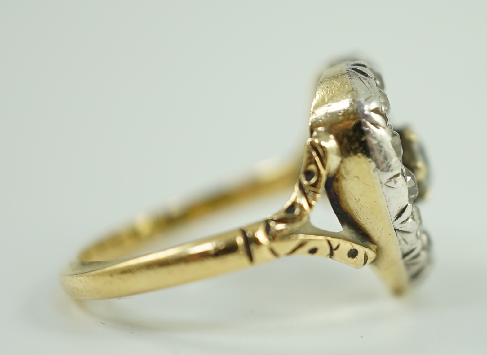 An antique gold and diamond set heart shaped open work cluster ring